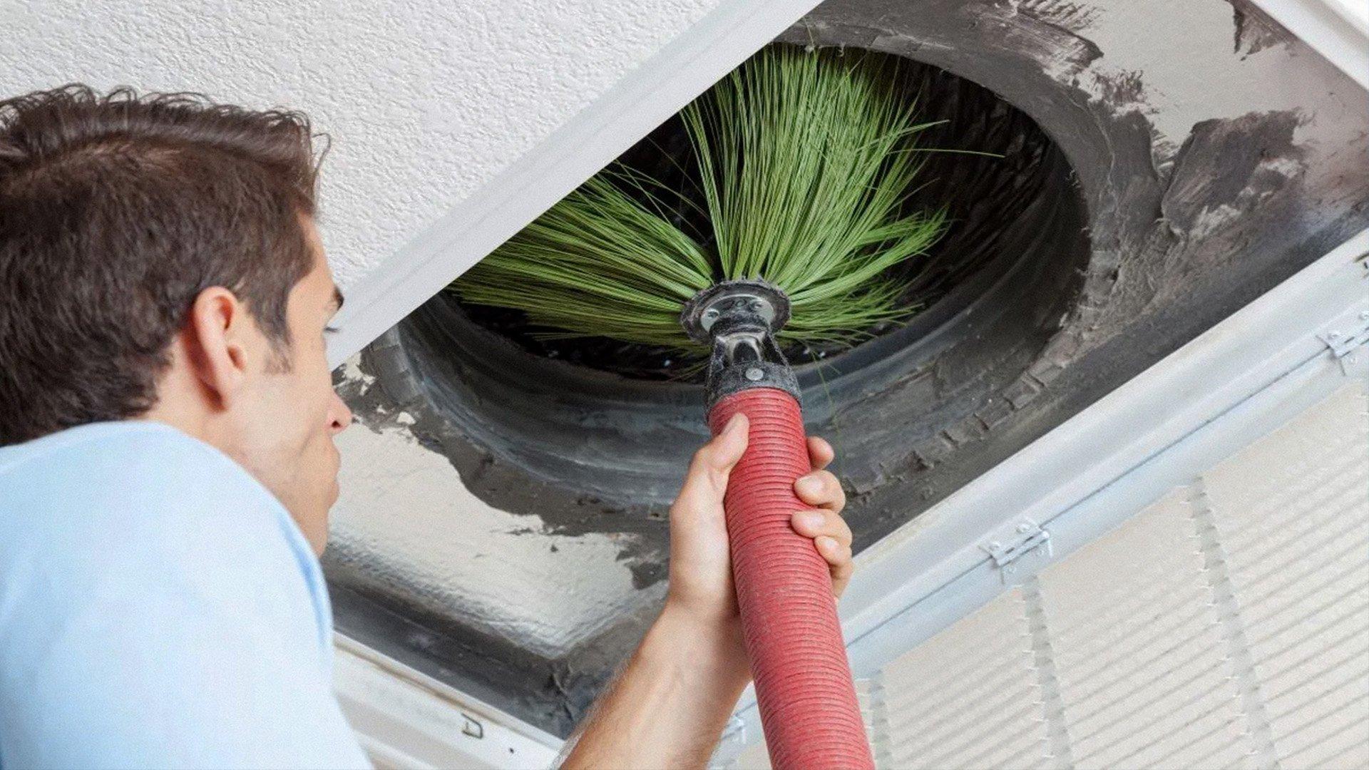 HVAC Technician uses bristled duct cleaning brush to clean residential duct. 